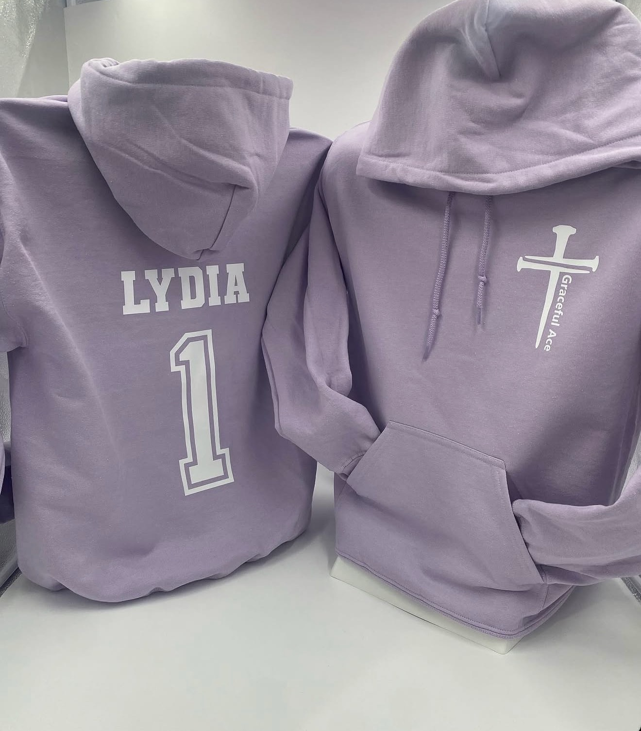Lavender hoodies with white Graceful Ace chest print and personalized Lydia number one back print