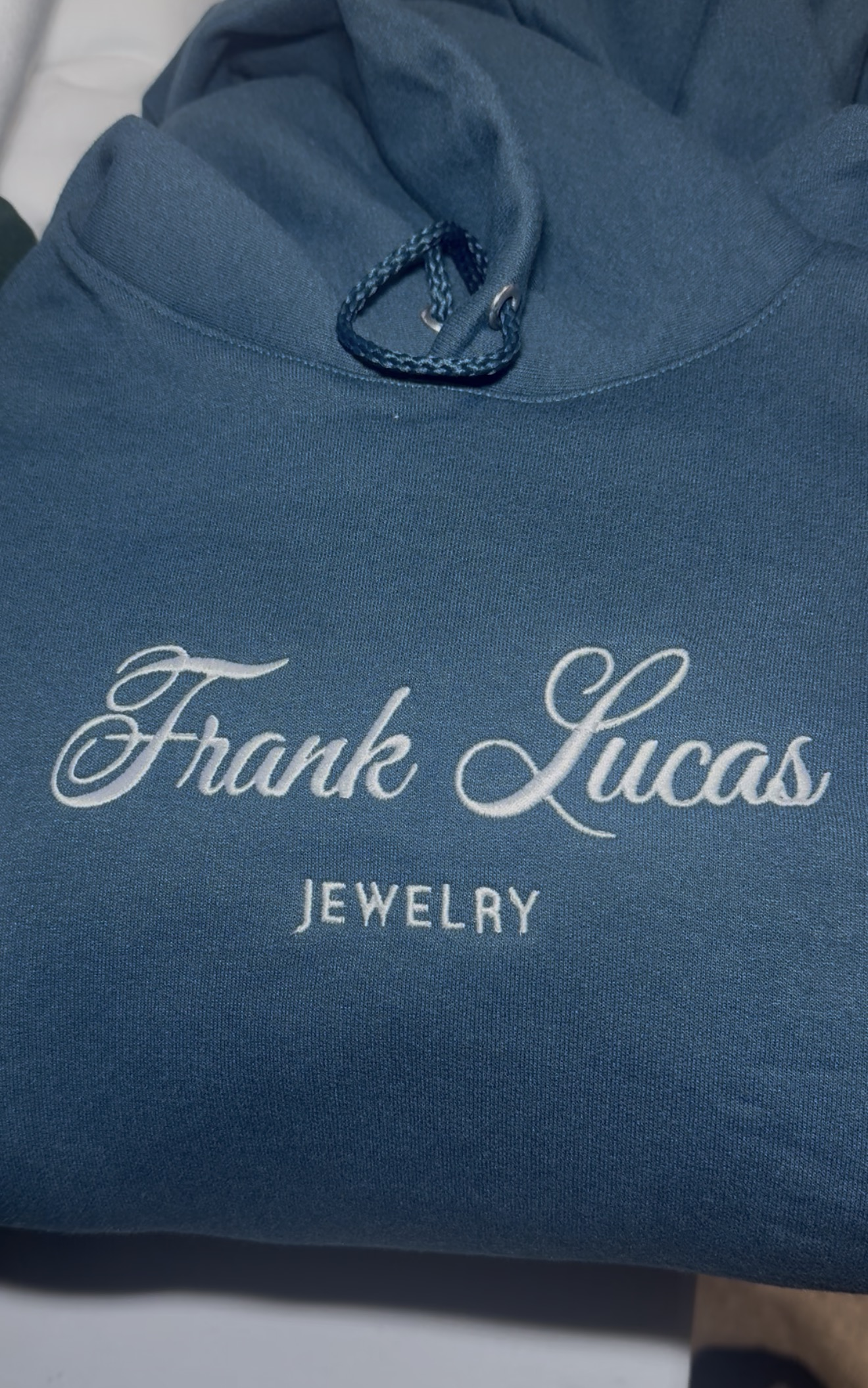 Blue hoodie with white Frank Lucas Jewelry embroidery
