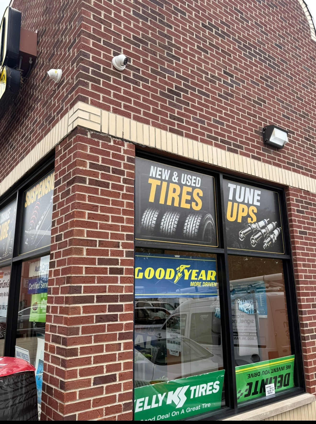 Auto shop storefront with printed tire, tune-up and suspension window graphics